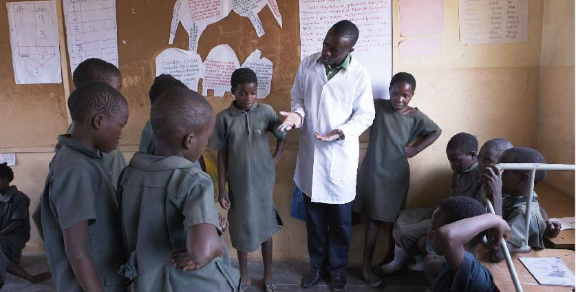 A teacher in a Catch Up classroom explains a reading activity during a TaRL class in Zambia.