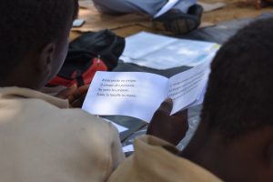 A child in Côte d'Ivoire reads a simple paragraph in French.